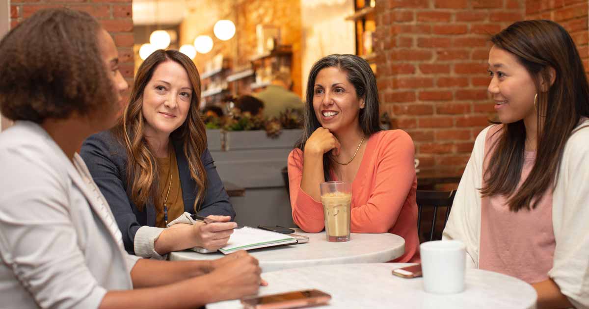 women chatting at cafe